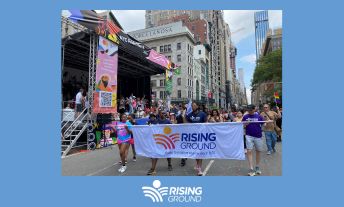 Travis Rodgers, center, and Rising Ground employees at the 2023 Pride March.
